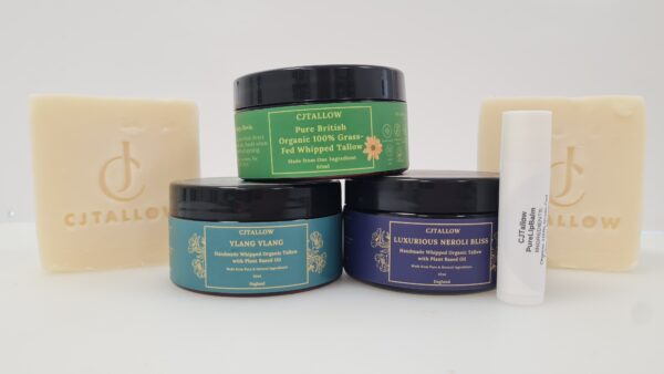 Group photo of CJTALLOW skincare products including two unscented tallow soaps, pure lip balm, Pure Tallow whipped moisturiser, Ylang Ylang and Neroli scented whipped tallow jars made from organic 100% grass-fed British tallow