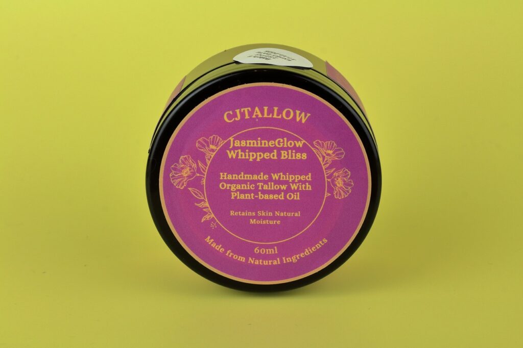60 ml jar of Jasmine-scented whipped organic tallow skin moisturiser by CJTALLOW, offering deep hydration and a luxurious floral aroma. In a pink label, food grade recycable tub