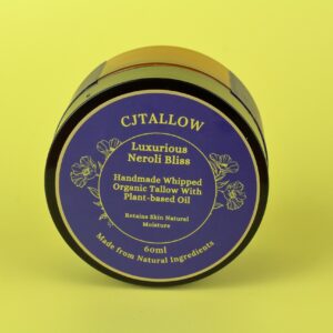 60ml jar of Neroli-scented whipped organic pasture-raised British tallow by CJTALLOW, blended with plant-based oils for natural skin hydration and nourishment. In Navy blue packaging. Made with natural ingredients to help retain skin's natural moisture.