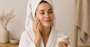 CJTallow tallow skincare routine with a woman in a bathrobe and towel applying natural moisturiser to her face